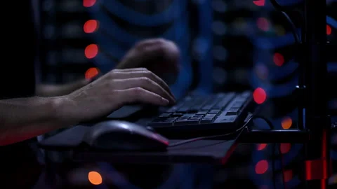 Close up of a man trying to fix an error on a computer in a server room Stock Footage 287370393