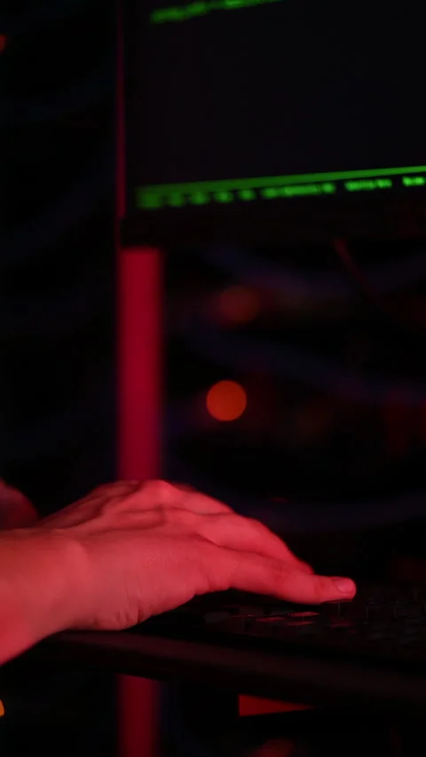 Close up of a man trying to fix an error on a computer in a server room. Stock Footage 287377549