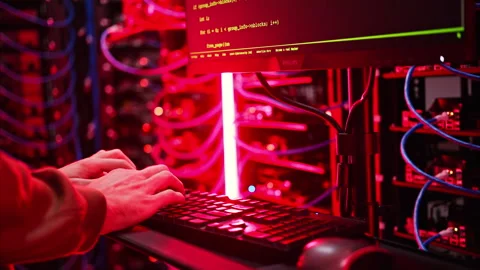 Close up of a man trying to fix an error on a computer in a server room Stock Footage 287405834