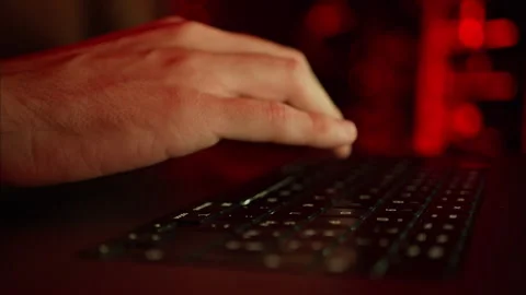 Close up of a man trying to fix an error on a computer in a server room Stock Footage 287405975