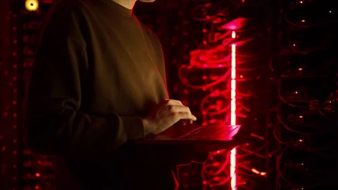 Close up of a man trying to fix an error on a computer in a server room Stock Footage 287406097