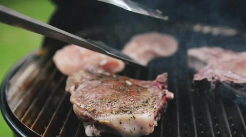 Close up of Man Turning Around Meat on the Barbecue Grill. Food Background Stock Footage 66882914