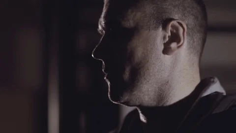 Close-up of man turning his head to look at camera. Видео 76907542