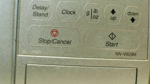 Close-up of a man turning on a microwave Stock-Footage 85077670