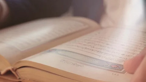 Close up man turning pages of holy Quran Koran Stock Footage 101387763