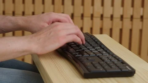 Close-up on a man typing on black keyboard with studio light Video stock 77409477