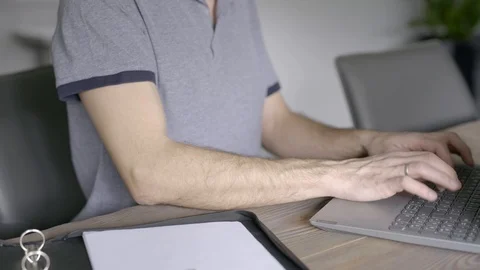 Close up of man typing on keyboard of laptop or computer Stock Footage 126780261