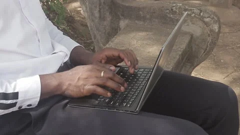 Close-up man typing on laptop in public park Stock Footage 292534218