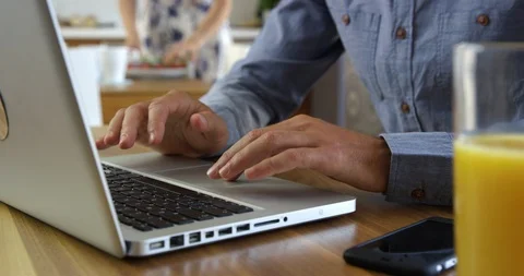 Close Up Of Man Typing On Laptop While Answering Call Stock Footage 124048495