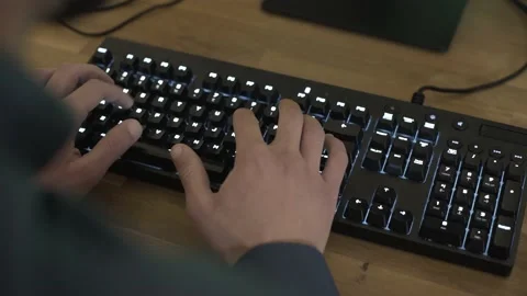 Close-up of man typing on mechanical keyboard on wooden desk Stock Footage 133262891