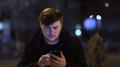 Close-up of a man typing a message on smartphones outdoors. Stock Footage 152983287