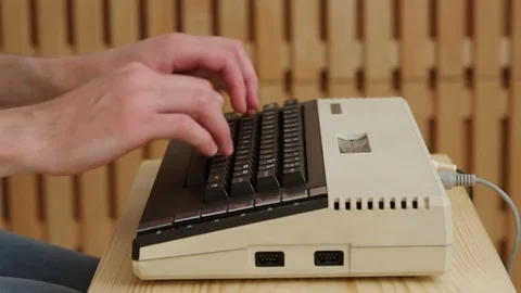 Close-up on a man typing on retro black keyboard with studio light Video stock 77409468