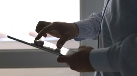 Close up of man typing on tablet computer with his finger Stock Footage 69064300