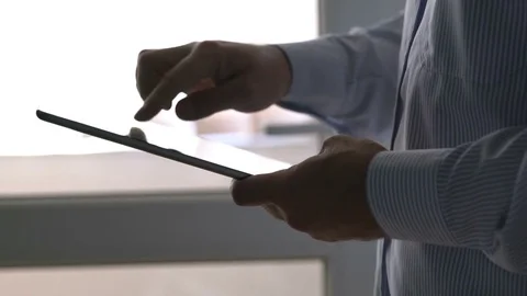 Close up of man typing on tablet computer with his finger Stock Footage 72179858