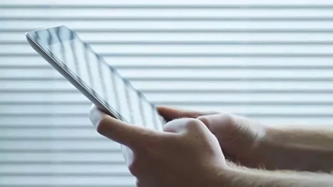 Close up of man typing on tablet computer with his finger Stock Footage 98248368