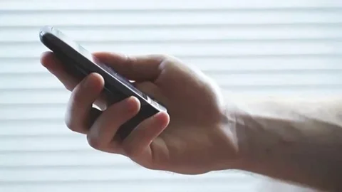 Close up of man typing on touchpad mobile phone with his fingers Stock Footage 98248378