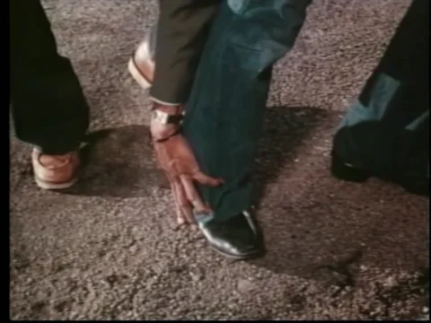 Close-up of man uncovering hidden object during pat down Stock Footage 260252909