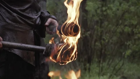 Close up of a man under the rain with torches in his hands Stock Footage 138425300