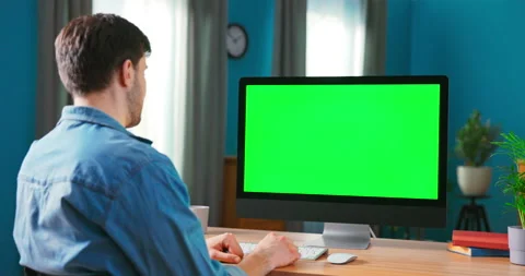 Close-up of a Man Uses Modern Computer with Green Mock-up Screen While Sitting Stock-Footage 154850893