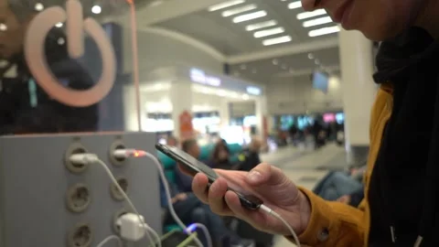 Close-up, a man uses a phone and charges it in a special place for charging with Stock Footage 192083113