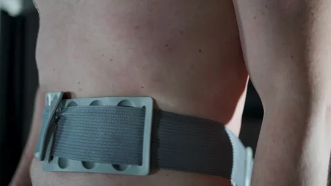 Close-up of Man Using Anti-Cellulite Belt Trainer. A person wearing massage.. Stock Footage 332335316