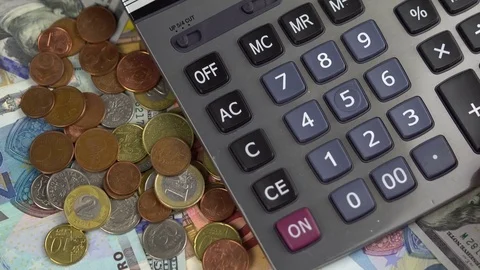 Close up man using calculator. Euro money - background with banknotes and coins Stock-Footage 73457355