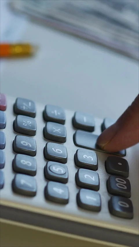 Close-Up Of Man Using Calculator. Vertical Stock Footage 284345321