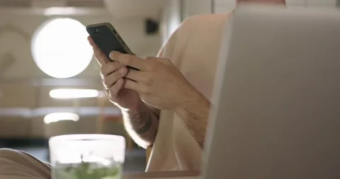 Close up of man using cell phone and laptop at cafe Stock Footage 159082539