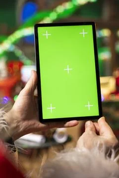 Close up of man using chroma key device going through Christmas wish lists Stock Photos