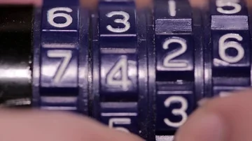 Close up of man using combination code to lock and chain Stock Footage 85937793