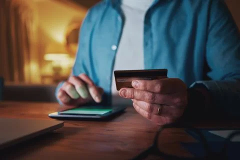 Close-up of man using credit card for paying on smart phone Stock Photos