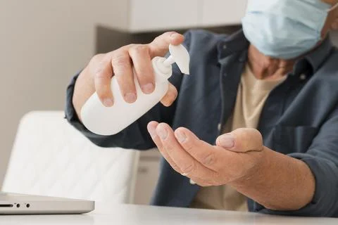 Close up man using disinfectant. High quality photo Stock Photos