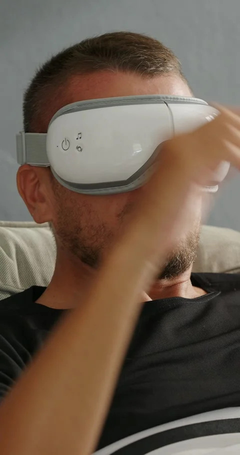 Close-up. Man using electric eye massager. Stock Footage 247159506