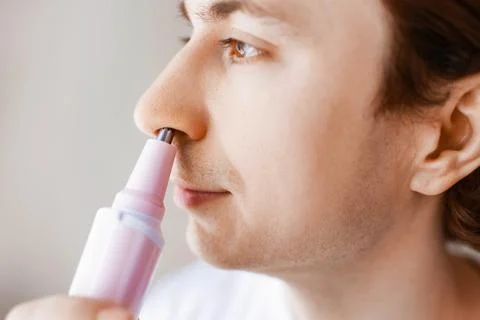 Close-up of a man using an electric trimmer for nose hair removal. A daily .. Stock Photos