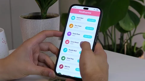 Close-up of a man using a food delivery app on a smartphone. Video stock 328494336