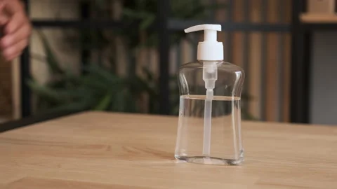 Close-up of man using hand sanitizer gel to prevent spreading virus or bacteria. Video stock 137604367