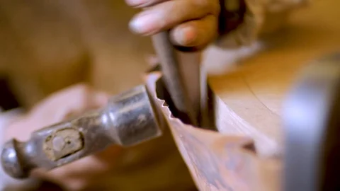 Close up of a man using hand tools to shape and bend a sheet of copper Stock Footage 98843166