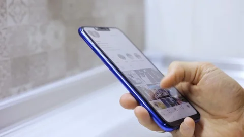 Close-up man using his smartphone with to scroll social app account, scrolling Stock Footage 99313640