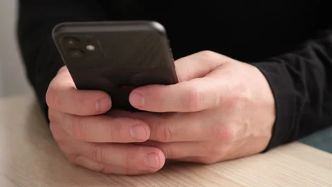 Close up man using iPhone 11, pressing fingers, typing text or shopping online Stock-Footage 255890234
