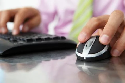 Close up man using  keyboard and mouse Stock Photos