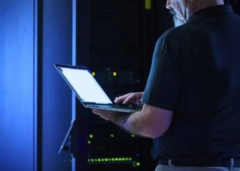 Close-up of man using laptop in data center Stock Photos