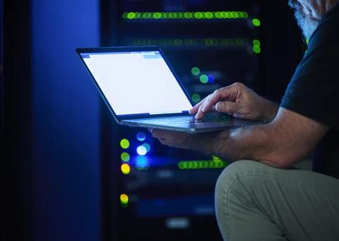 Close-up of man using laptop in data center Stock Photos