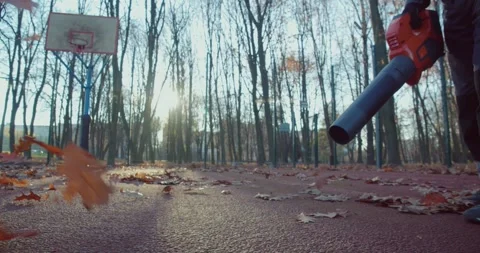 Close up of man in using leaf blower for cleaning city park Stock Footage 251805354