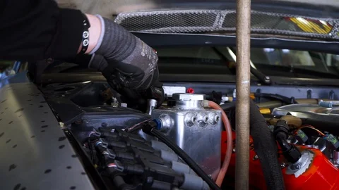Close-up of man using metal tools to repair car. Footage. Professional auto Video stock 129087254