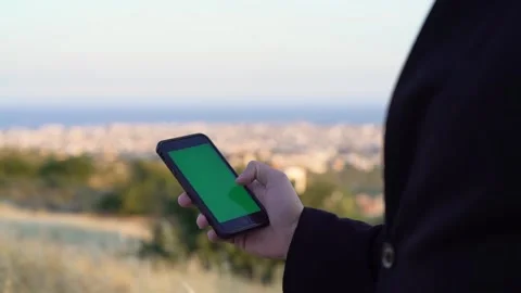 Close-up of man using mobile phone with green screen outdoors Stock Footage 133374172