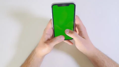 Close-up of man using a mobile phone and fast typing on green screen chroma key. Stock Footage 192966518