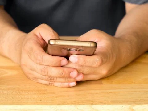 Close up of a man using mobile smart phone. holding touch screen smartphone. Stock Photos