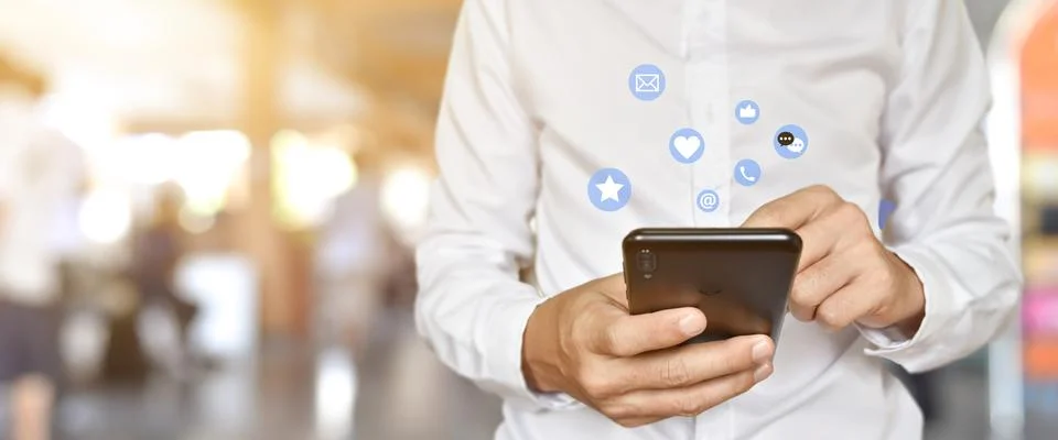 Close up of man using mobile smartphone with social, media icons. Marketing o Stock Photos