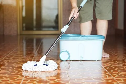 Close up of man using a mop to mop the floor Stock Photos