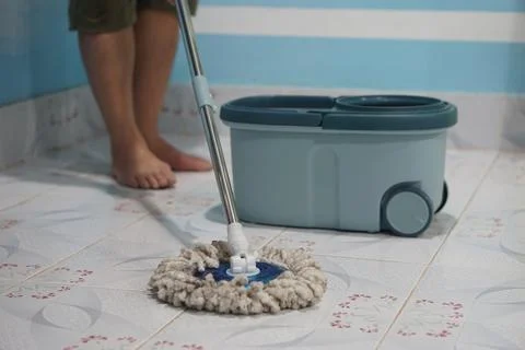 Close up of man using a mop to mop the floor Stock Photos